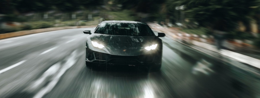 Blog header image of a fast car racing along a road for the blog on the Faster, Easier Way to Manage KPIs in 2021 with Reporting Software blog from Solver, a developer of Corporate Performance Management / Budgeting and Reporting software